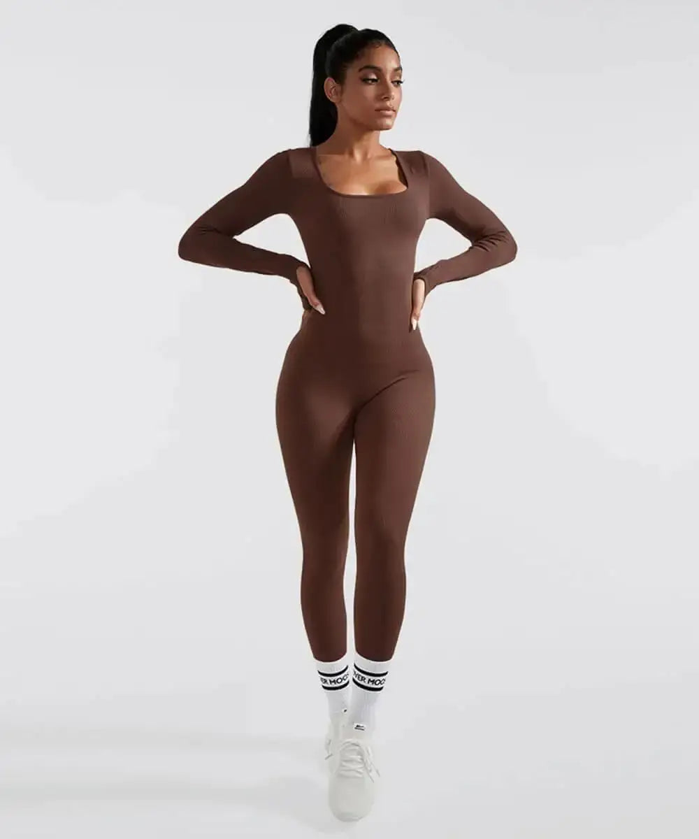 Woman wearing a brown long sleeve shapewear bodysuit with tummy control, standing confidently in a stylish pose