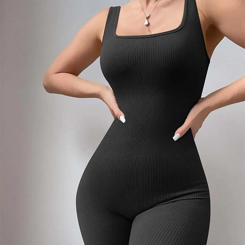 Model wearing a black ribbed women's jumpsuit showcasing a comfortable and elegant fit suitable for casual to active wear.