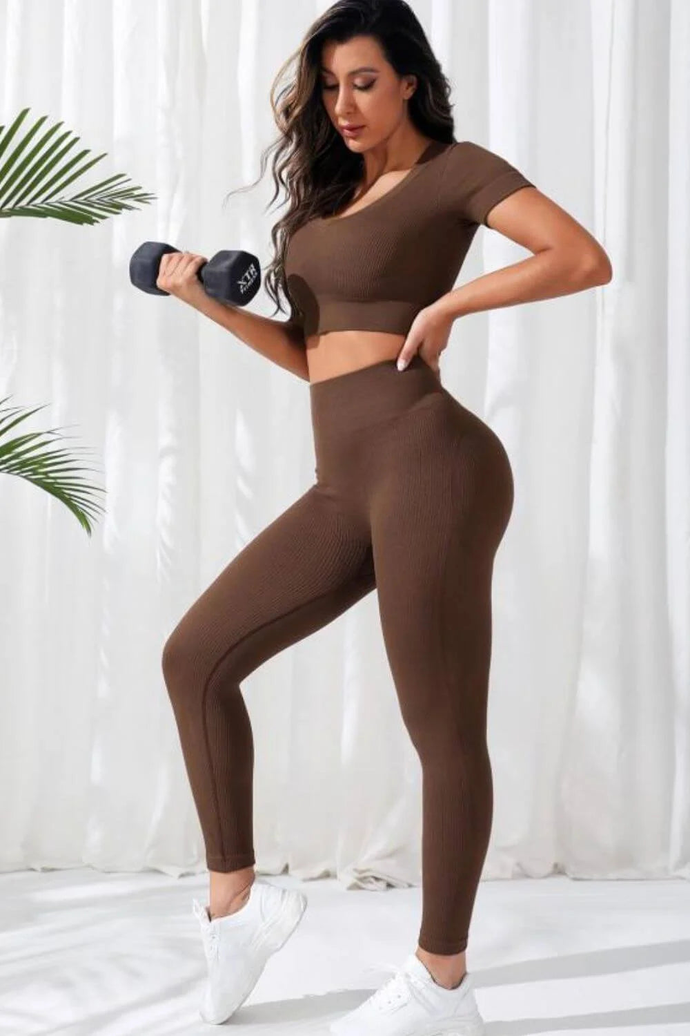 Woman wearing Women’s Seamless V-Neck Crop Top & High-Waist Leggings Set, ideal for yoga with a sporty slim fit style.